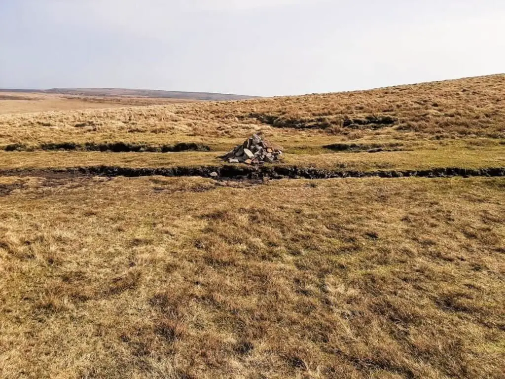 stone cairn indicating summit of Pen Y Manllwyn