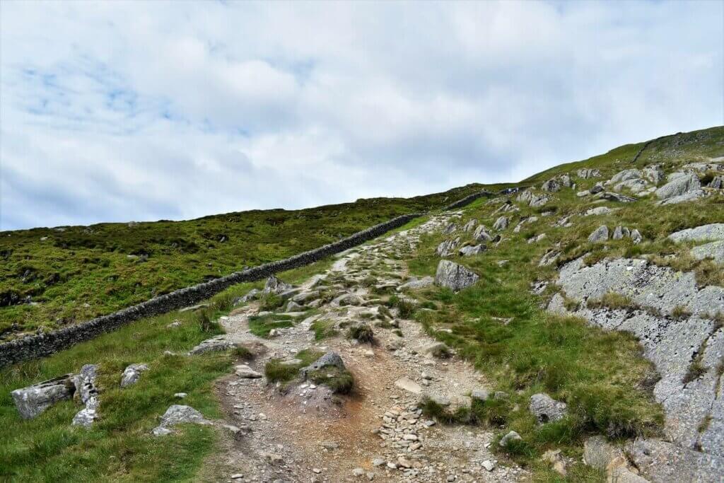 helvellyn walking trail veers right at stone wall